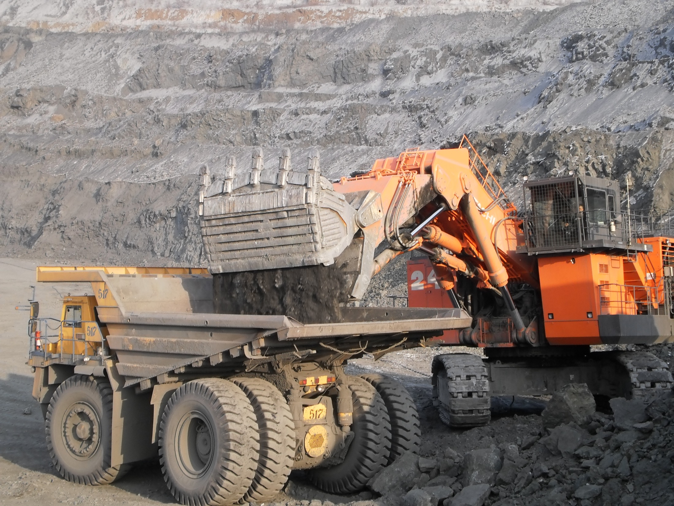 Mining excavator loading material into haul truck