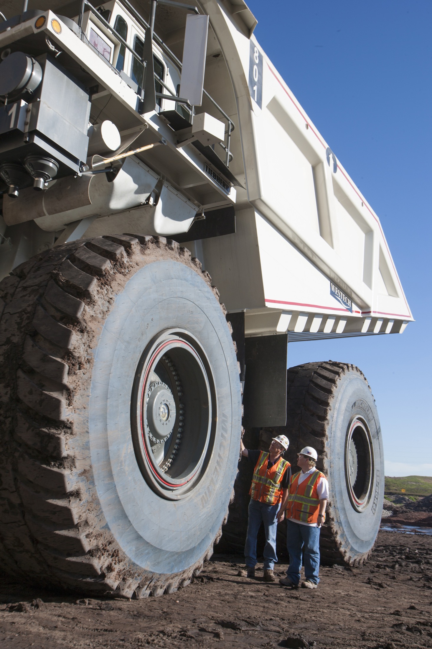 Mining team standing near a large coal haul truck